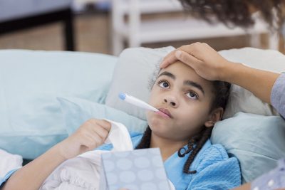 Sick child with thermometer Getty Images 664785834
