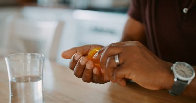 Man taking medication Getty Images 1208575544