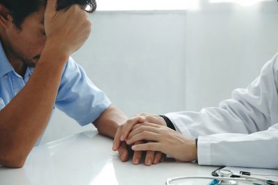 Physician consoling family member Getty Images 1351647744