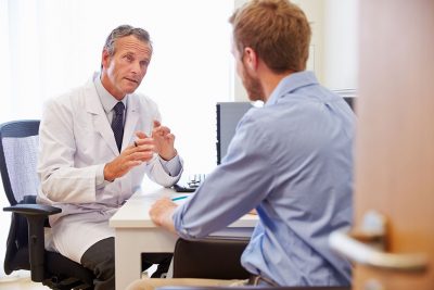 Doctor and male patient consultation Getty Images 489347248
