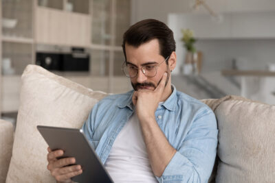 Man looking at ipad Getty Images 1337484953