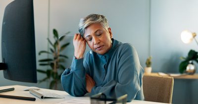 Stressed woman at desk Getty Images 1718173220