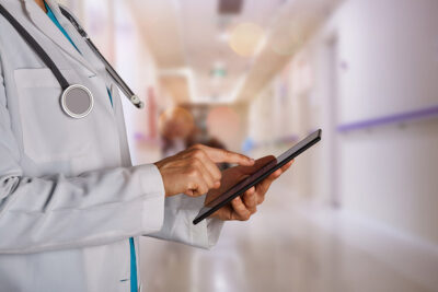 Doctor looking at EMR Getty Images 1217648324