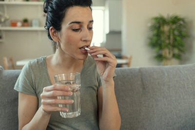 Woman taking medication Getty Images 1205344326